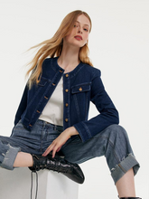a lady sitting in dark blue jean jacket with jeans and white T-shirt